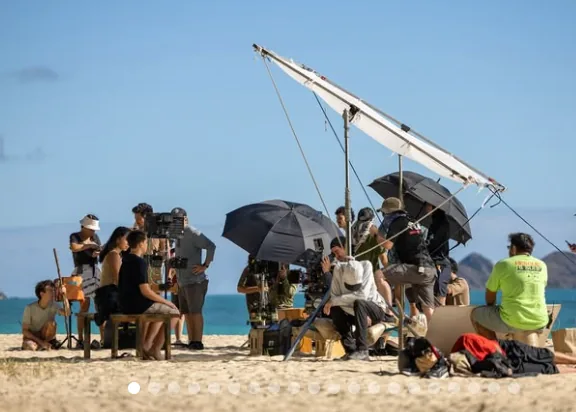 A film crew working on a beach